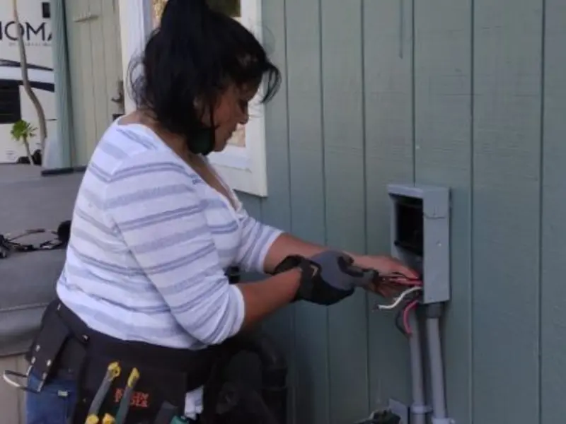 Licensed electrician wiring an exterior subpanel in Holloman AFB