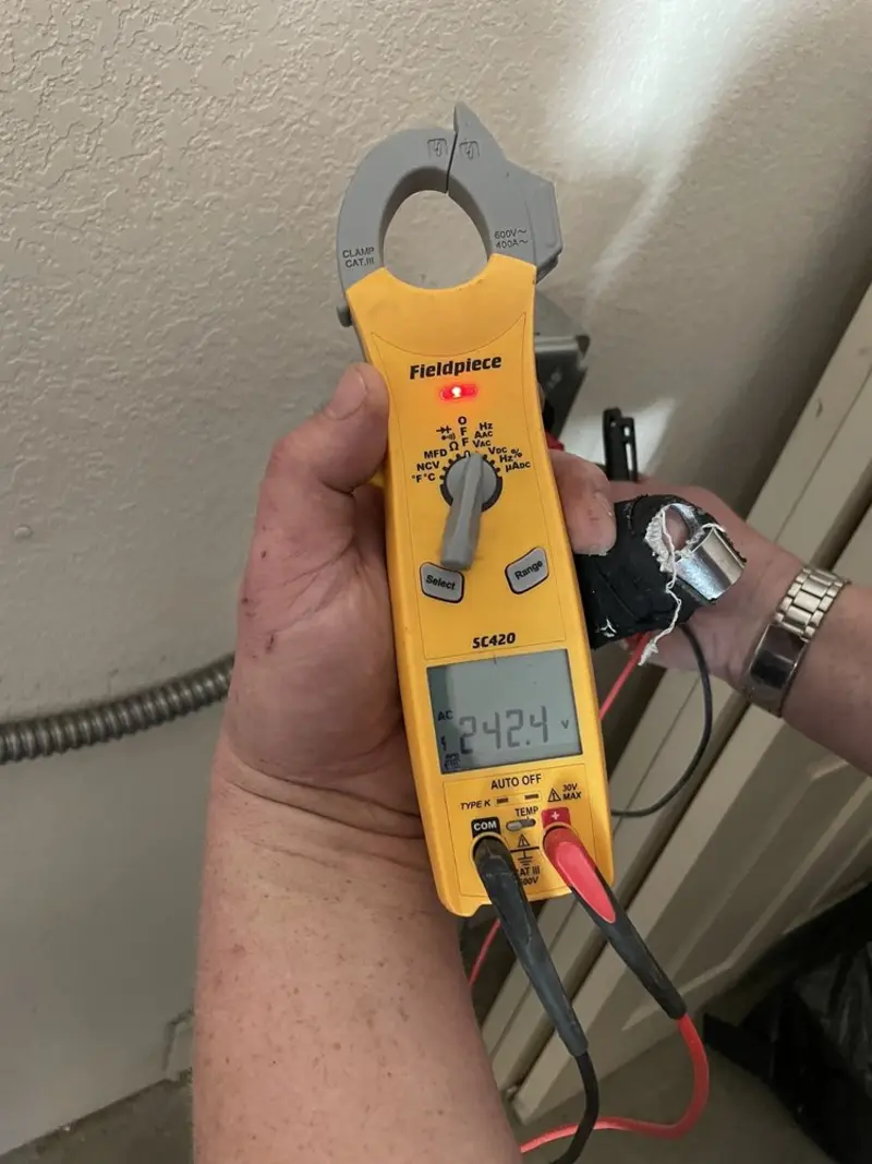 Voltage testing with clamp meter during Outlet Installation in Holloman AFB